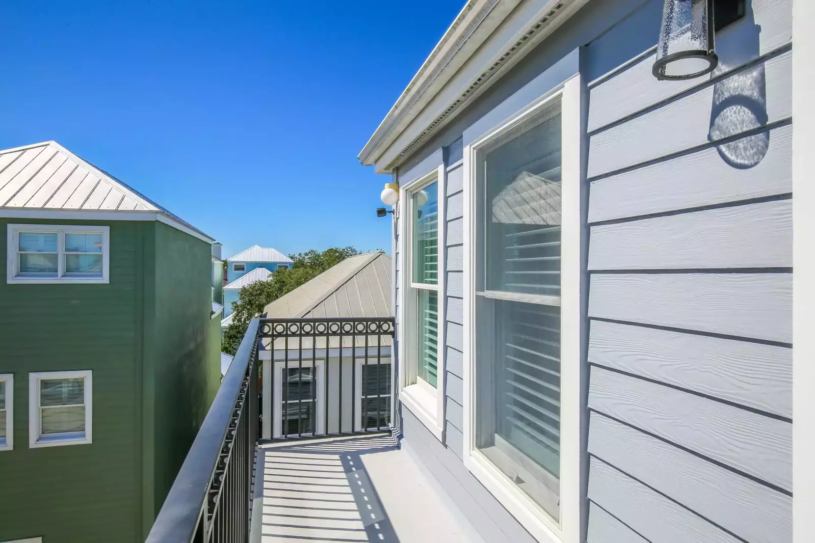 The private balcony is the perfect spot to soak up the sun and enjoy the colorful homes in the neighborhood.