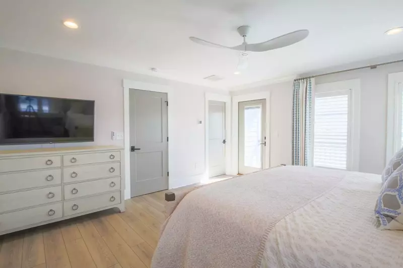 The master suite also features a mounted smart TV and access to a private balcony.