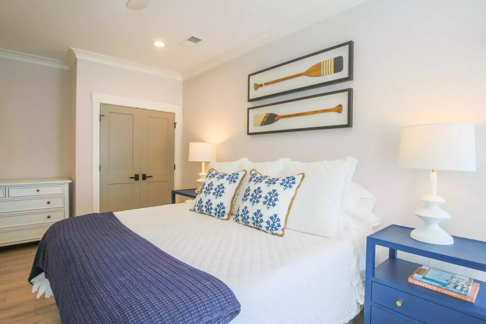 The second master suite features night stands with reading lamps and a dresser.