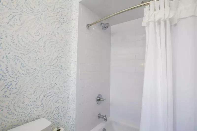 The en suite bathroom for the second master suite also has a shower/tub combo.