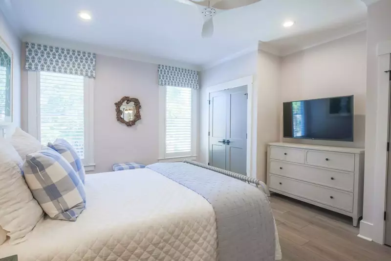 This guest bedroom also has a dresser and a wall-mounted streaming TV.