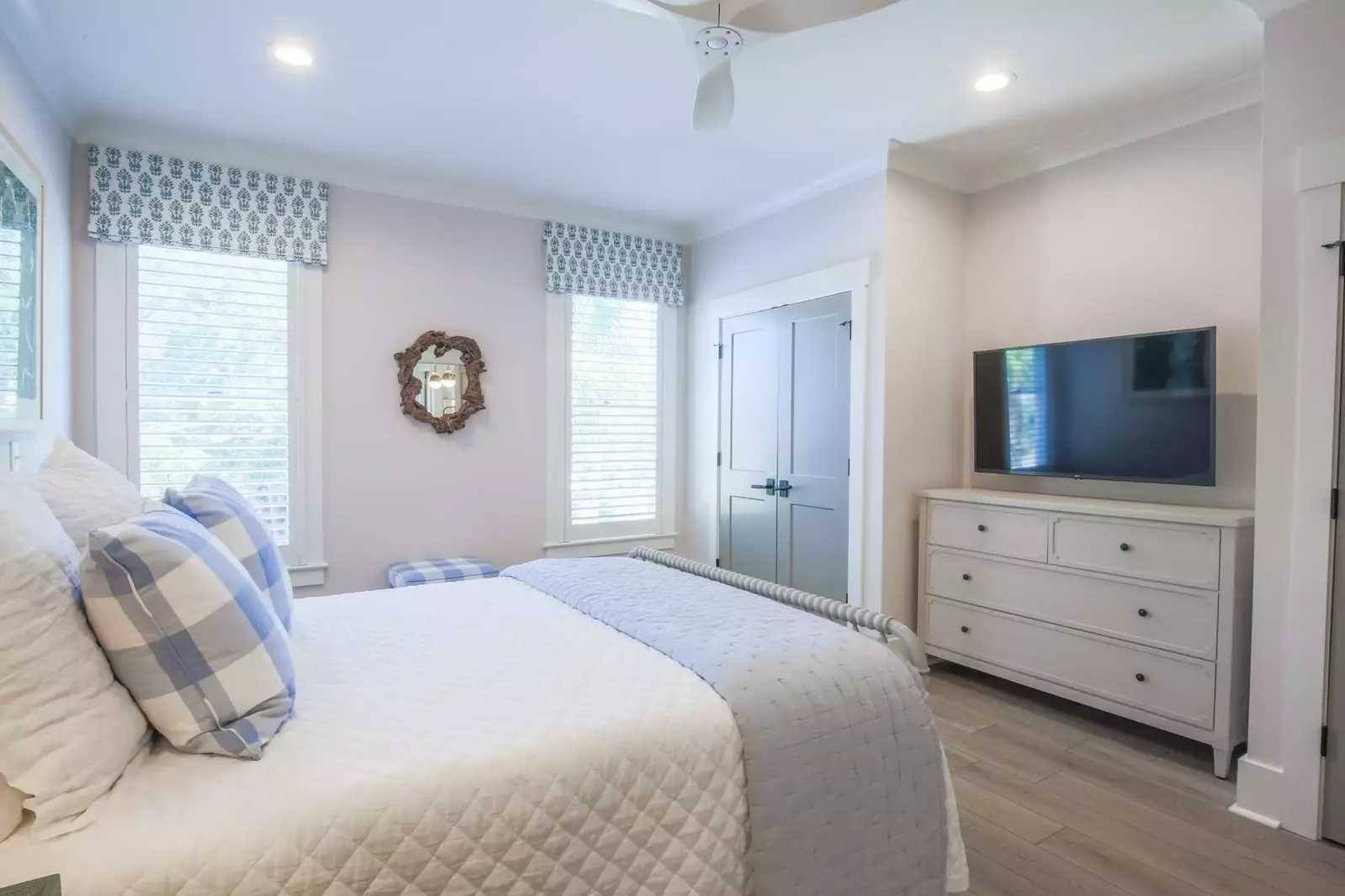 This guest bedroom also has a dresser and a wall-mounted streaming TV.