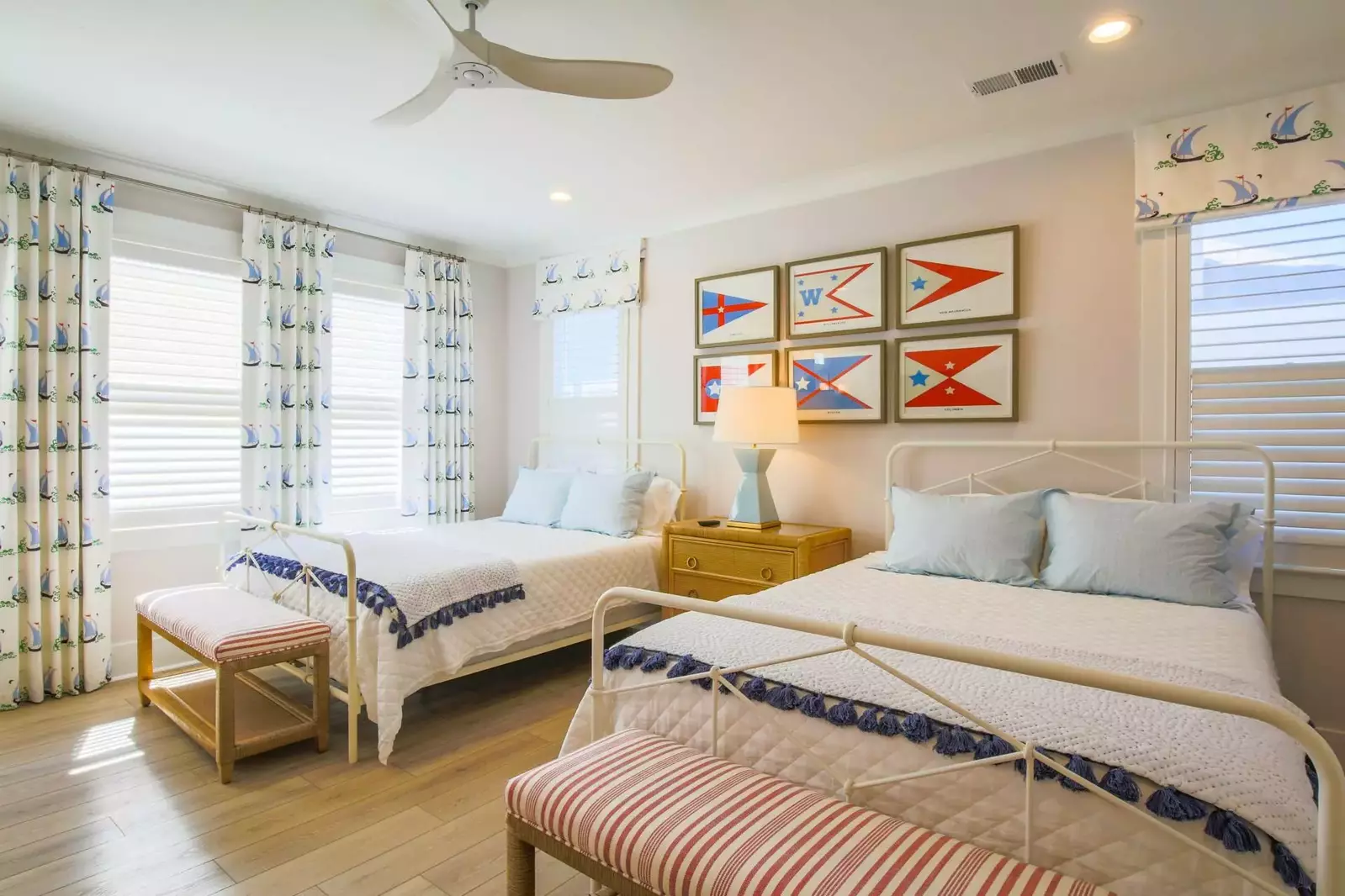 This guest suite features two queen beds, nautical themed decor and lovely natural light.