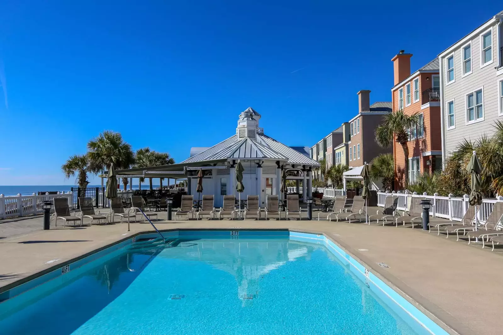 Follow the boardwalk until you reach the two community pools and beach cafe!