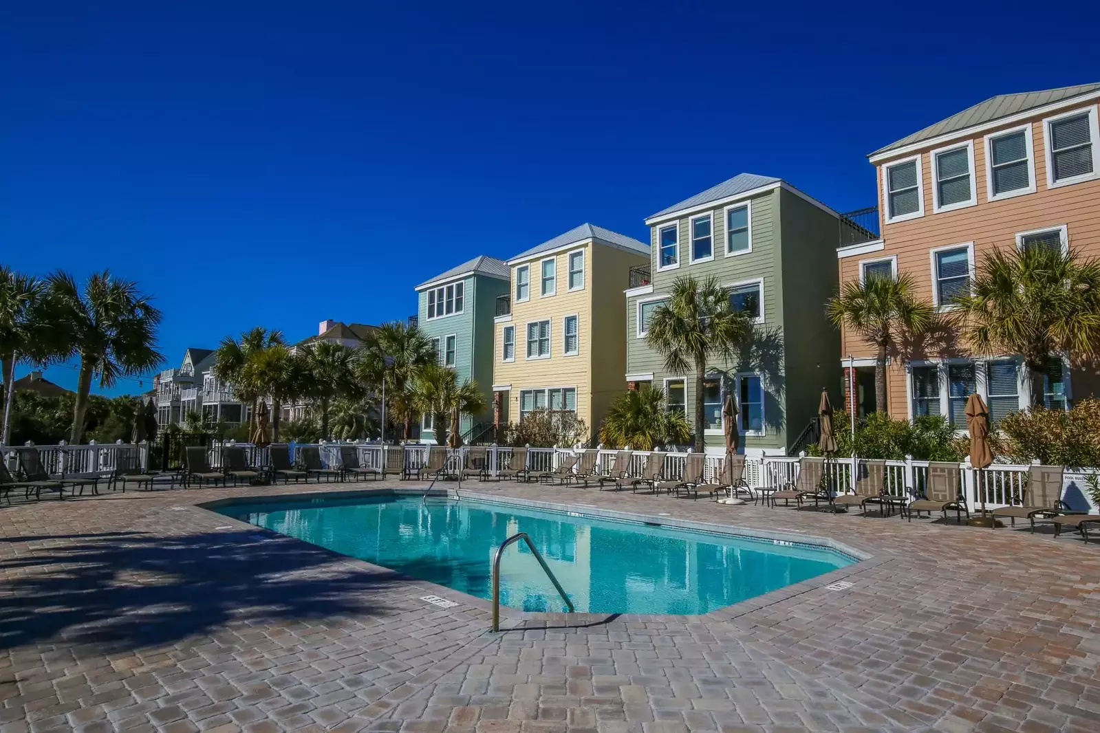 There are many lounge chairs that surround both of the community pools.