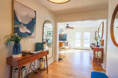 The main level of Heron Hideaway features hardwood floors and double door access to the back deck.