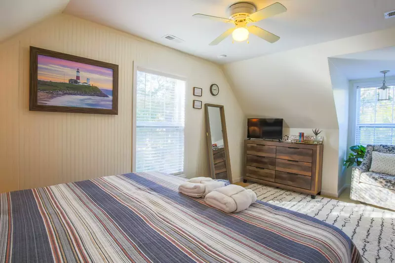 This upstairs bedroom also features a full length mirror and wonderful natural light.