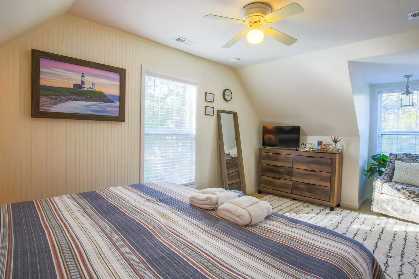 This upstairs bedroom also features a full length mirror and wonderful natural light.