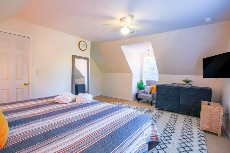 There is also an arm chair, dresser and full length mirror in this guest bedroom.
