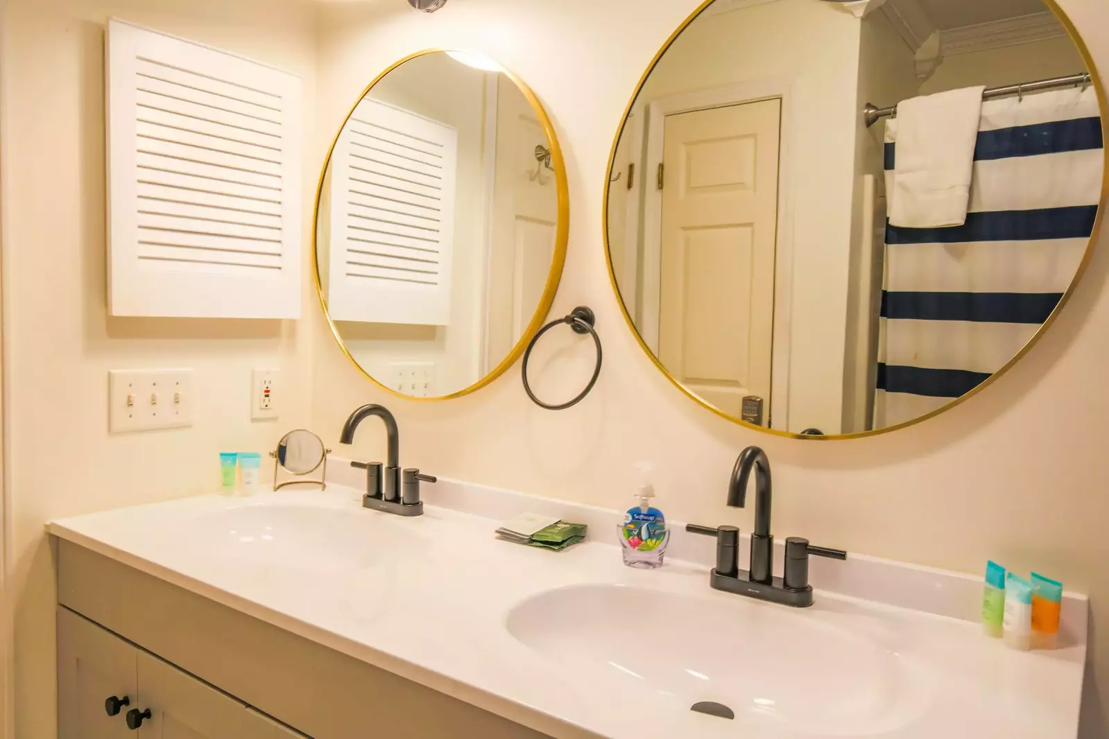 The first floor hallway bathroom has a spacious, two-sink vanity.
