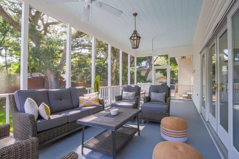 The screen door on the far side of the screened porch connects to the back deck.