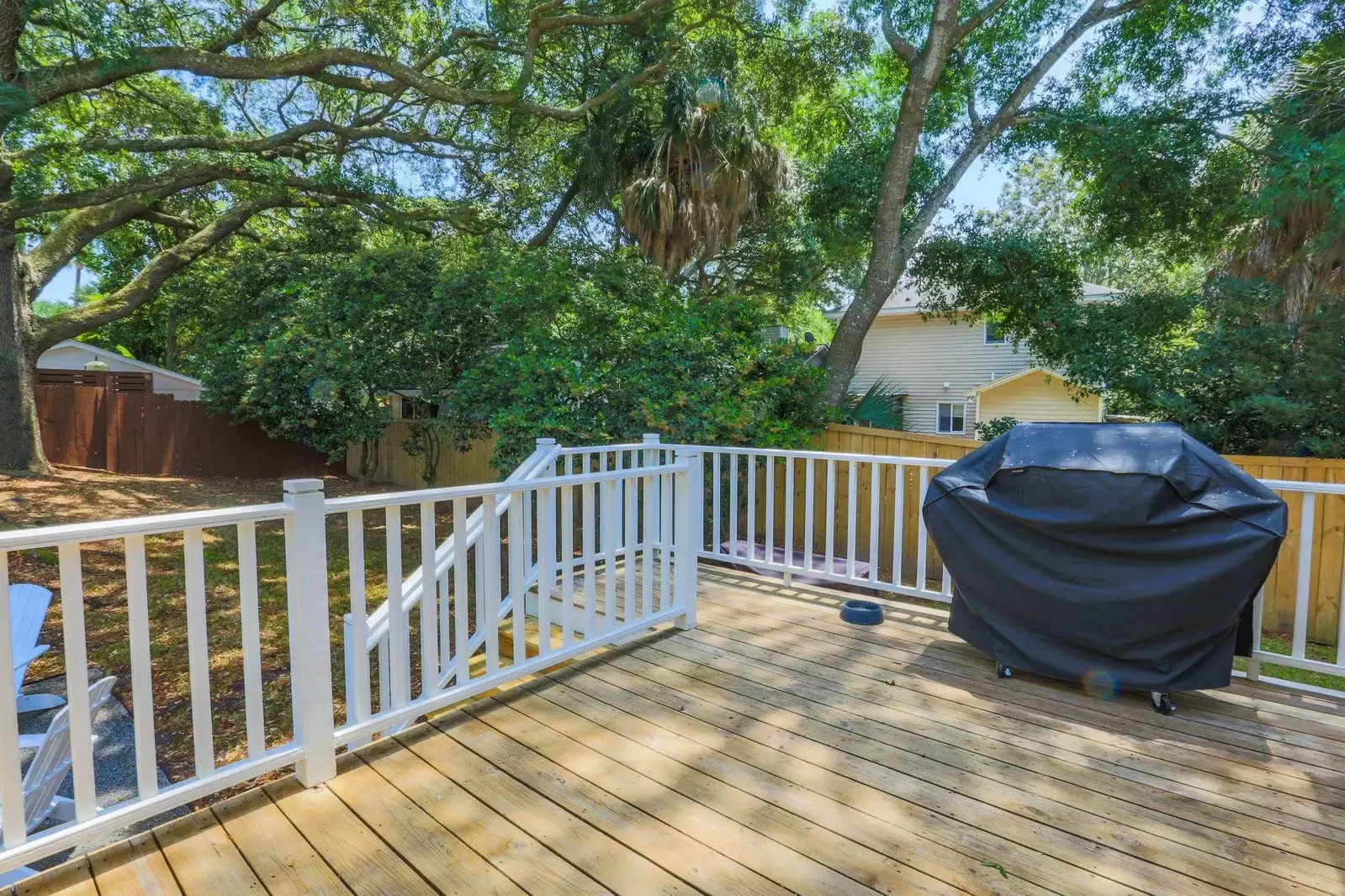 On the deck, you will find a propane BBQ grill and steps down to the backyard.