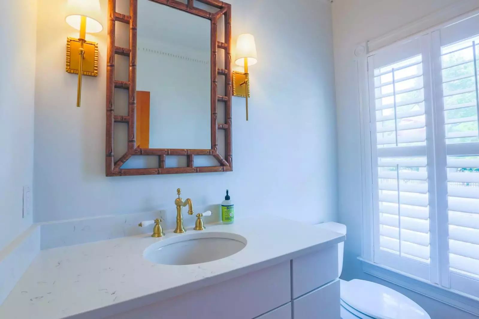 This half bathroom is located on the ground floor near the front door of the house.
