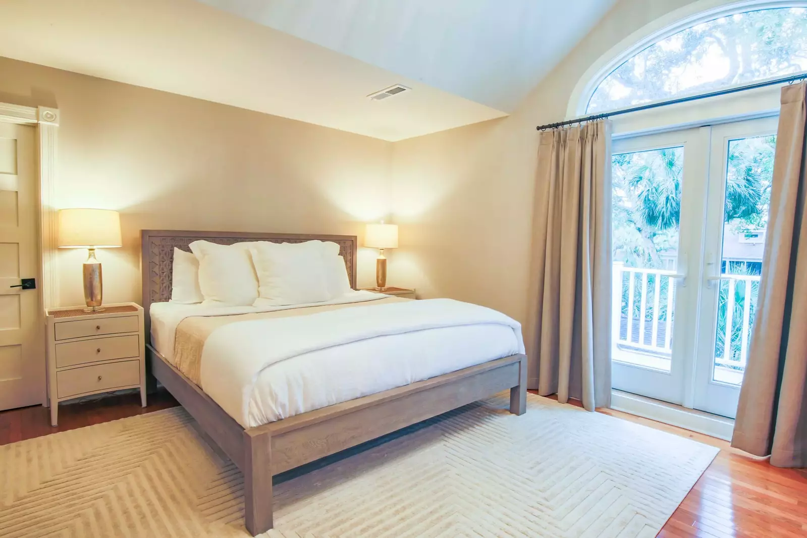 The master suite is located on the second floor and features a king bed and access to an outdoor balcony.