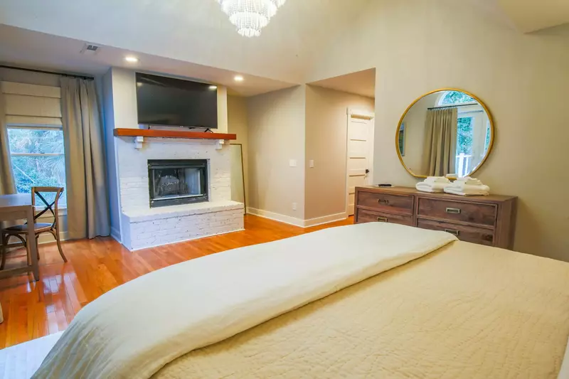 The master suite also features a dresser and wall-mounted streaming tv.  (Fireplace is not available for guest use.)