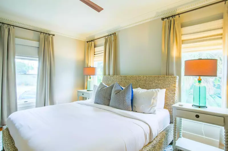 This downstairs master suite features a king bed and terrific natural light.