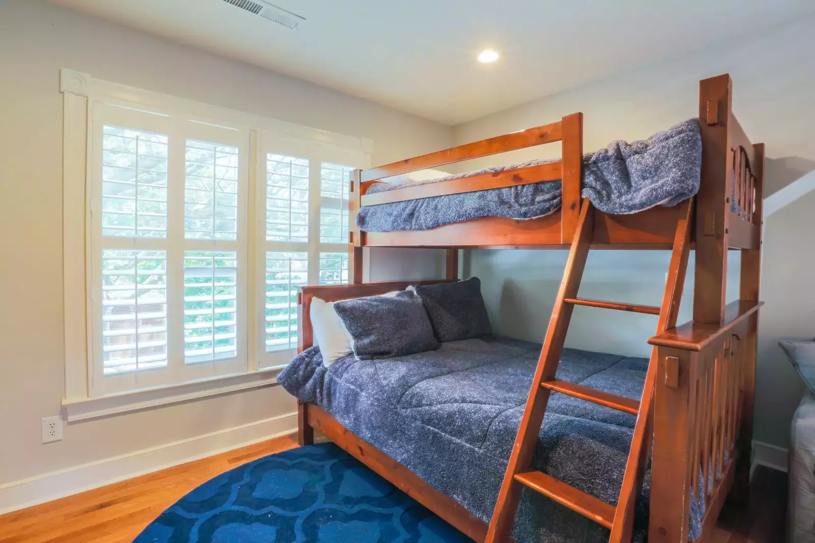 There is a full bunk bed on the bottom bunk and a twin bed on the upper bunk.
