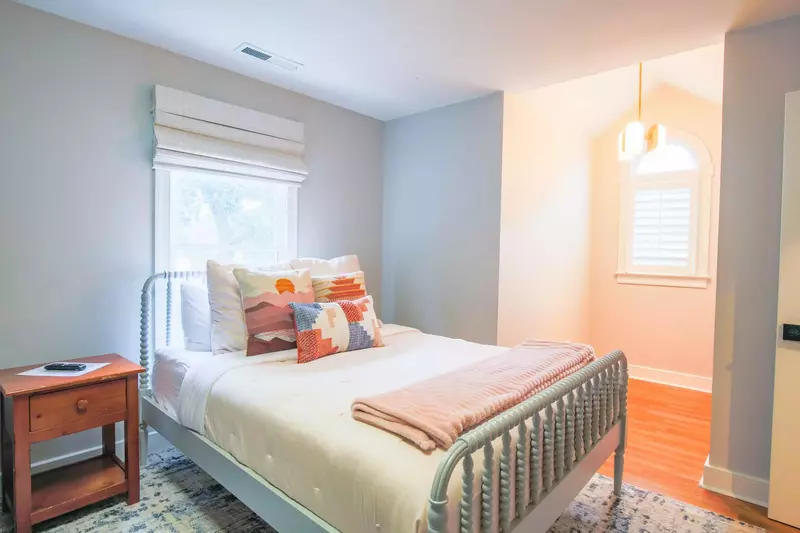 This queen bed is located within the bunk bedroom.