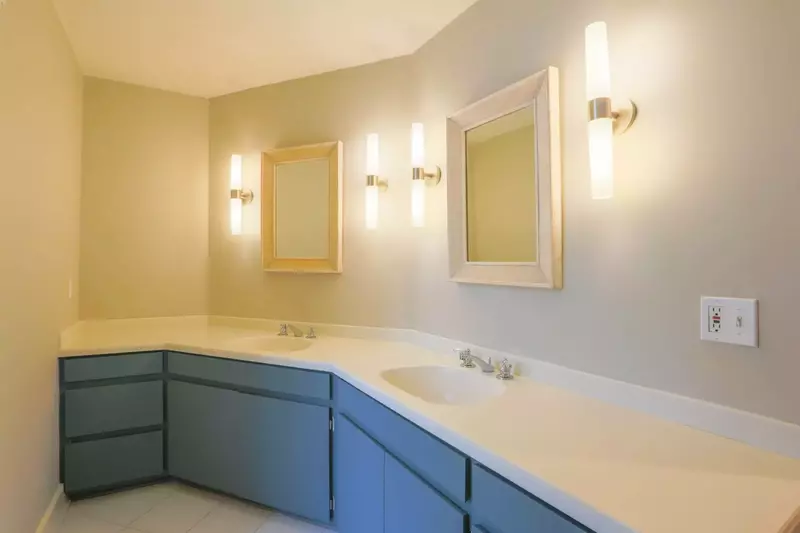 This hallway bathroom on the second floor features a spacious, two sink vanity.