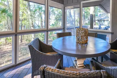 Riverhouse's screened porch and back deck feature views of the Kiawah River.