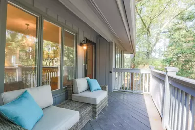 When you walk up the home's exterior staircase, you will be welcomed by this comfortable front porch.