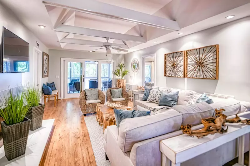 The home's three bedrooms, the kitchen and the screened porch all extend off of the living room.