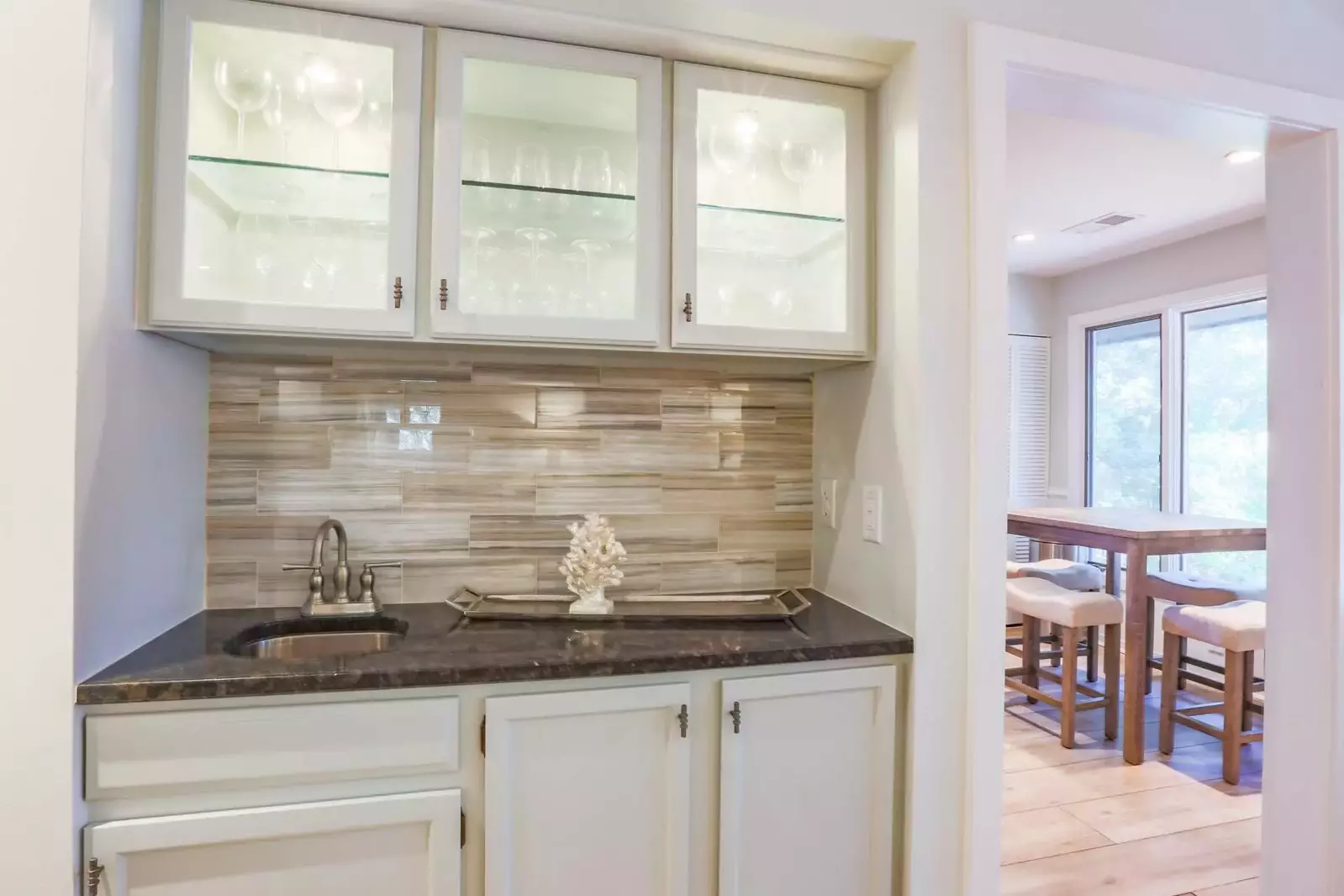 The entrance to the kitchen is adjacent to the butler's pantry and dining area.