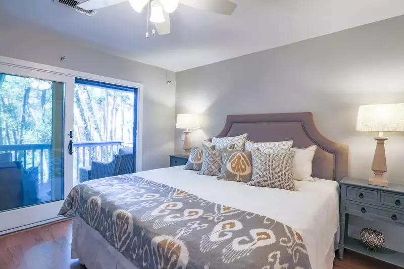 The master bedroom features a king bed and sliding door access to the back deck.