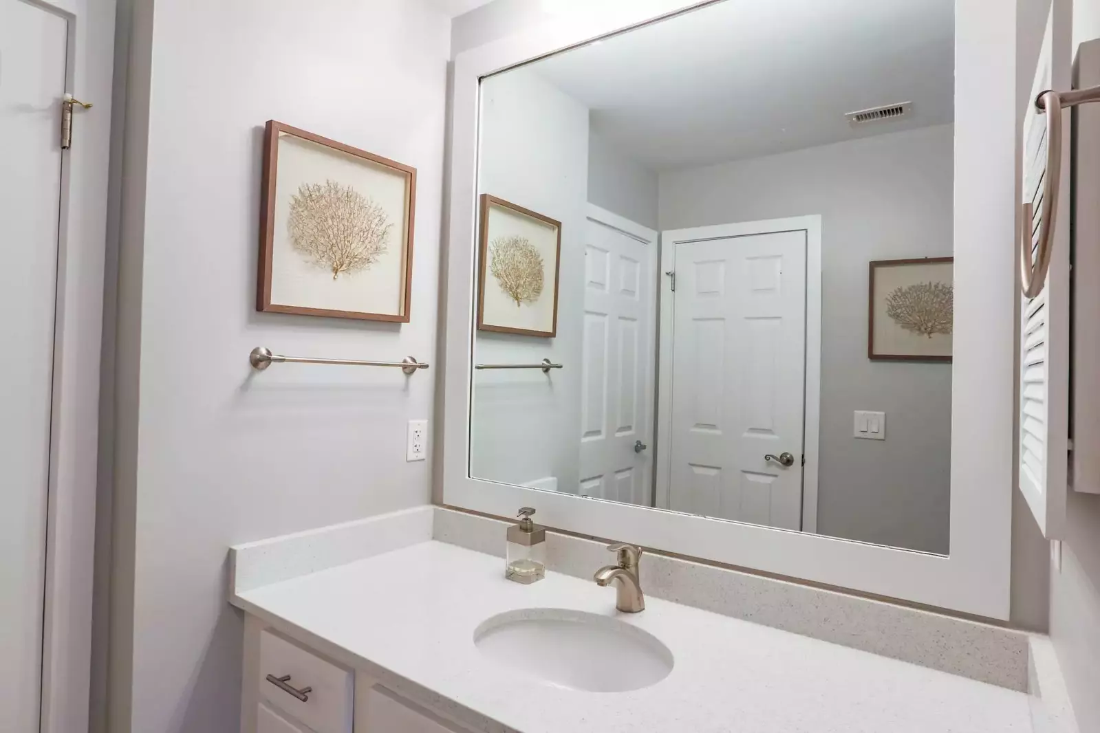 The en suite bathroom for the master bedroom has a spacious vanity and a separate room with shower & commode.