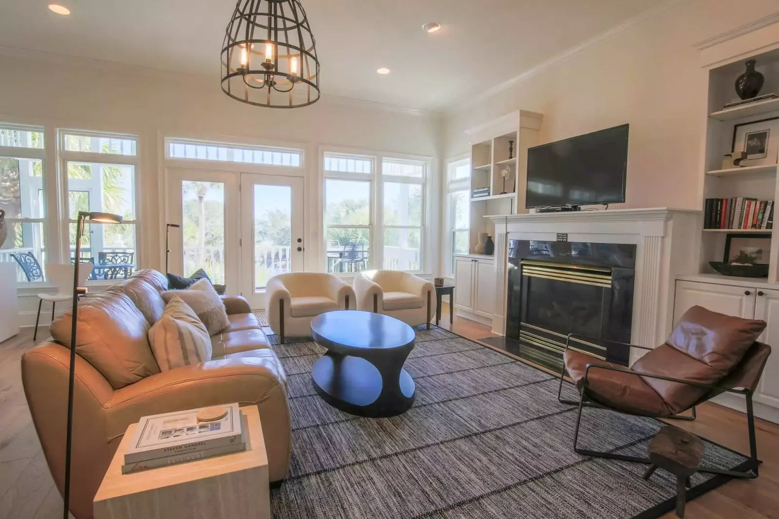 The living room features access to the screened porch and views of the Ocean Point community pool.
