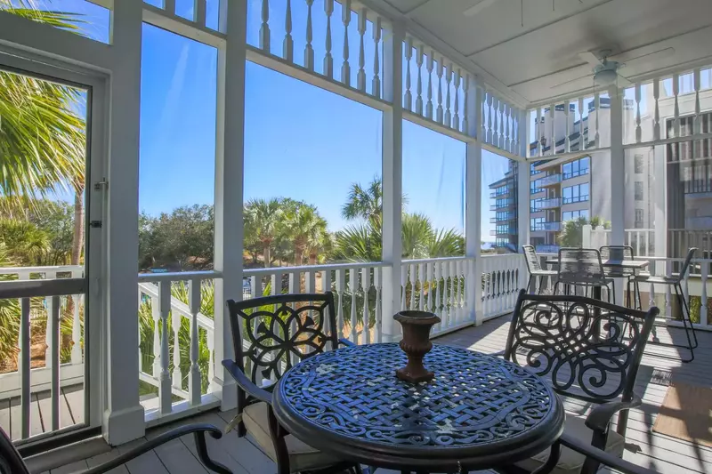 The two dining tables on the screened porch each seat 4.
