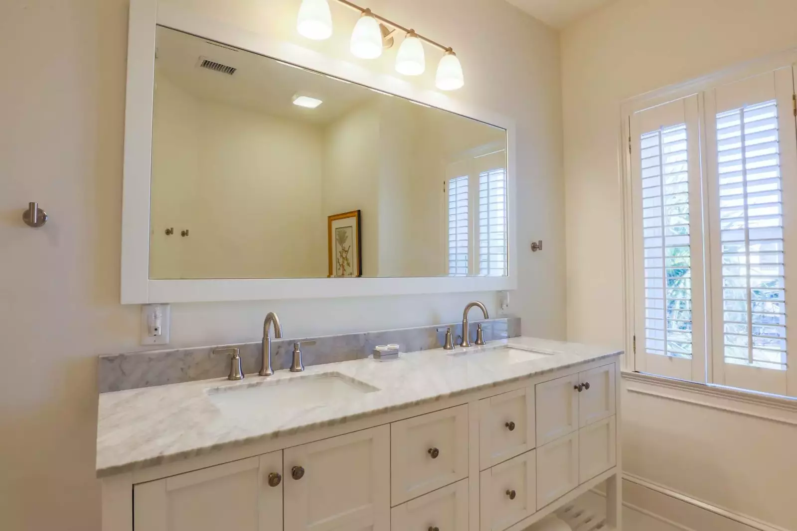 The en suite bathroom for the second master suite has a double sink vanity.