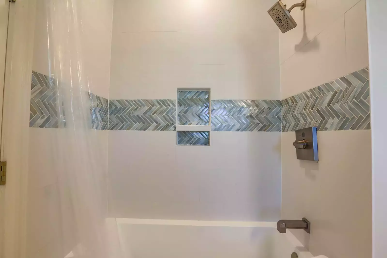 The en suite bathroom also has a tiled shower/tub.