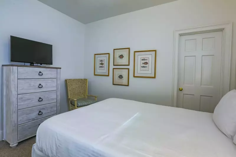 This guest bedroom also has a dresser, streaming TV and an en suite bathroom.