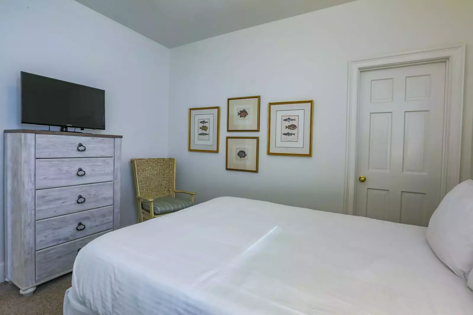This guest bedroom also has a dresser, streaming TV and an en suite bathroom.
