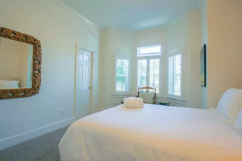 This guest bedroom also has a bathroom that is accessible via the hallway.