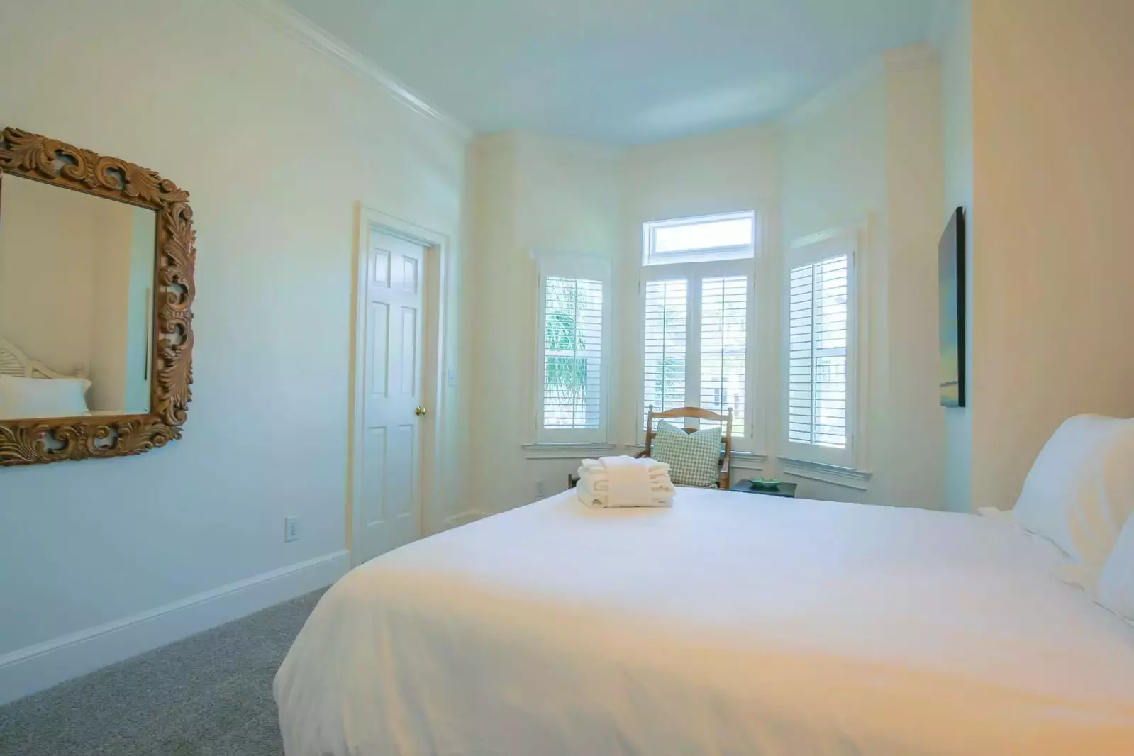 This guest bedroom also has a bathroom that is accessible via the hallway.