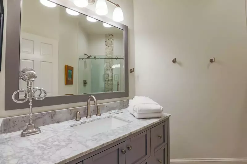 The lower level bathroom features a spacious vanity and a tiled walk-in shower.
