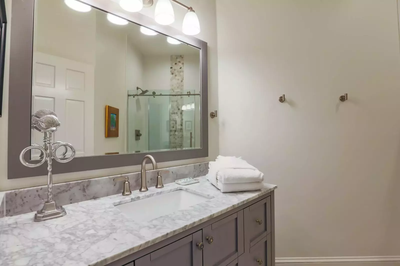 The lower level bathroom features a spacious vanity and a tiled walk-in shower.