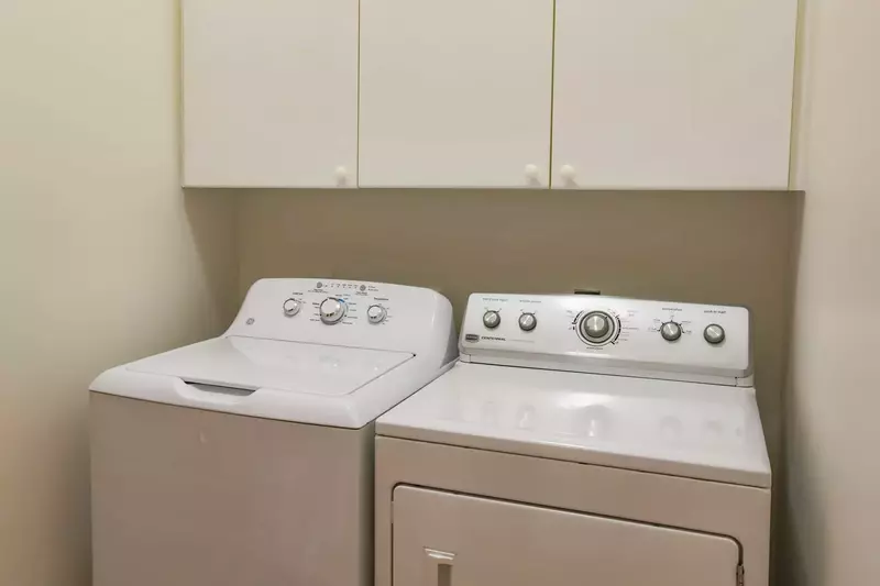 There is a full sized washing machine and dryer in the laundry room behind the kitchen.