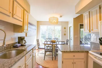 The spacious kitchen opens onto the sunny dining area.