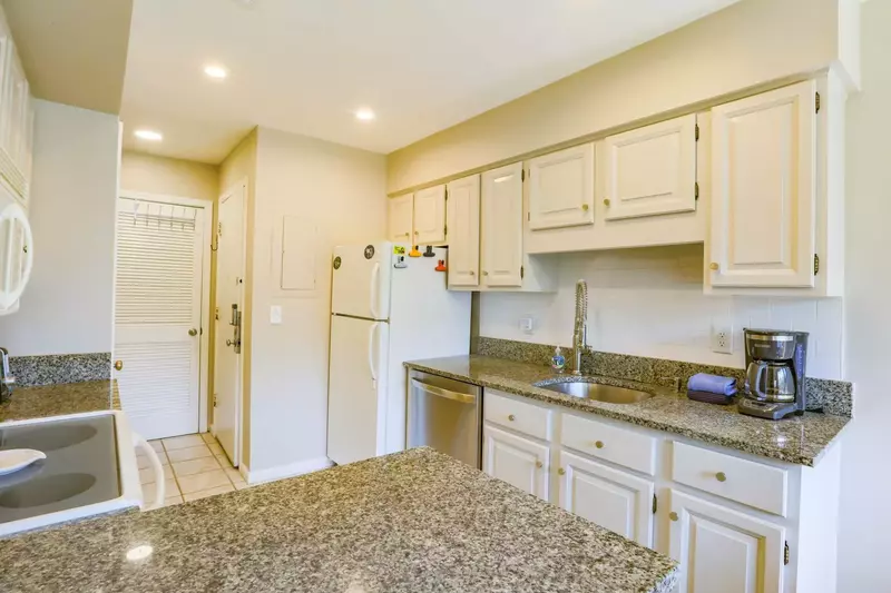 The kitchen features a refrigerator, dishwasher, coffee maker and garbage disposal.