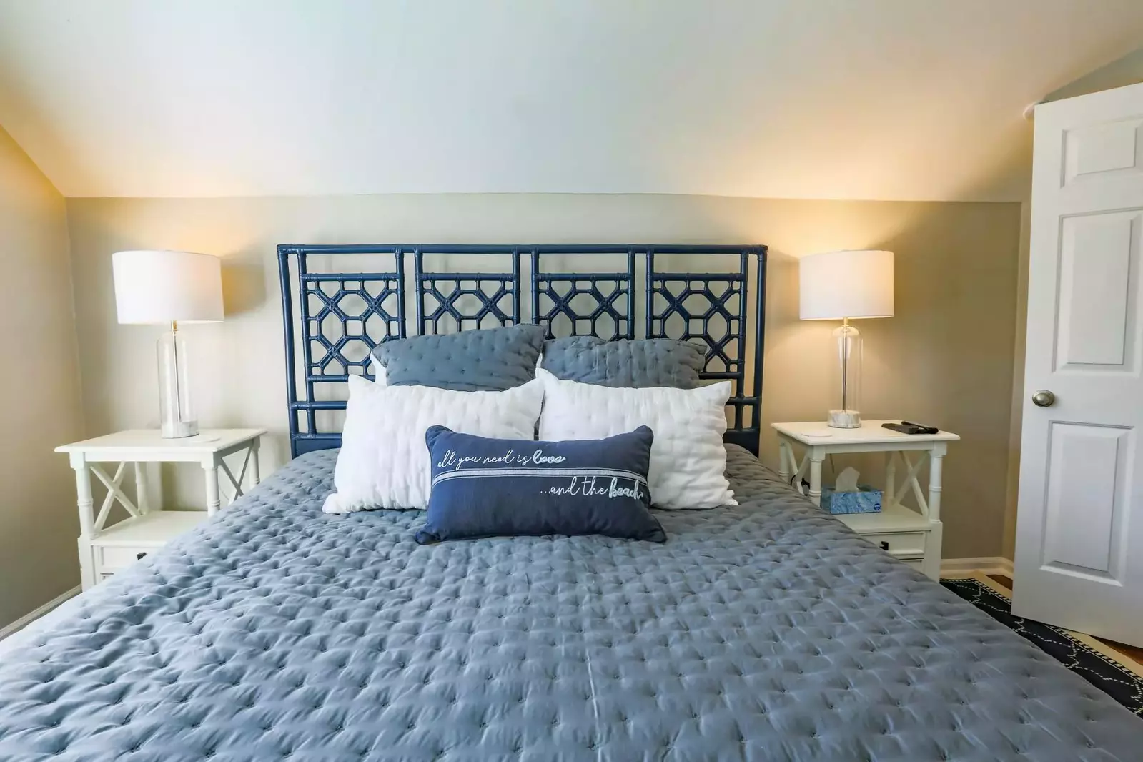 The master suite features a king bed, night stands with reading lamps and an en suite bathroom.