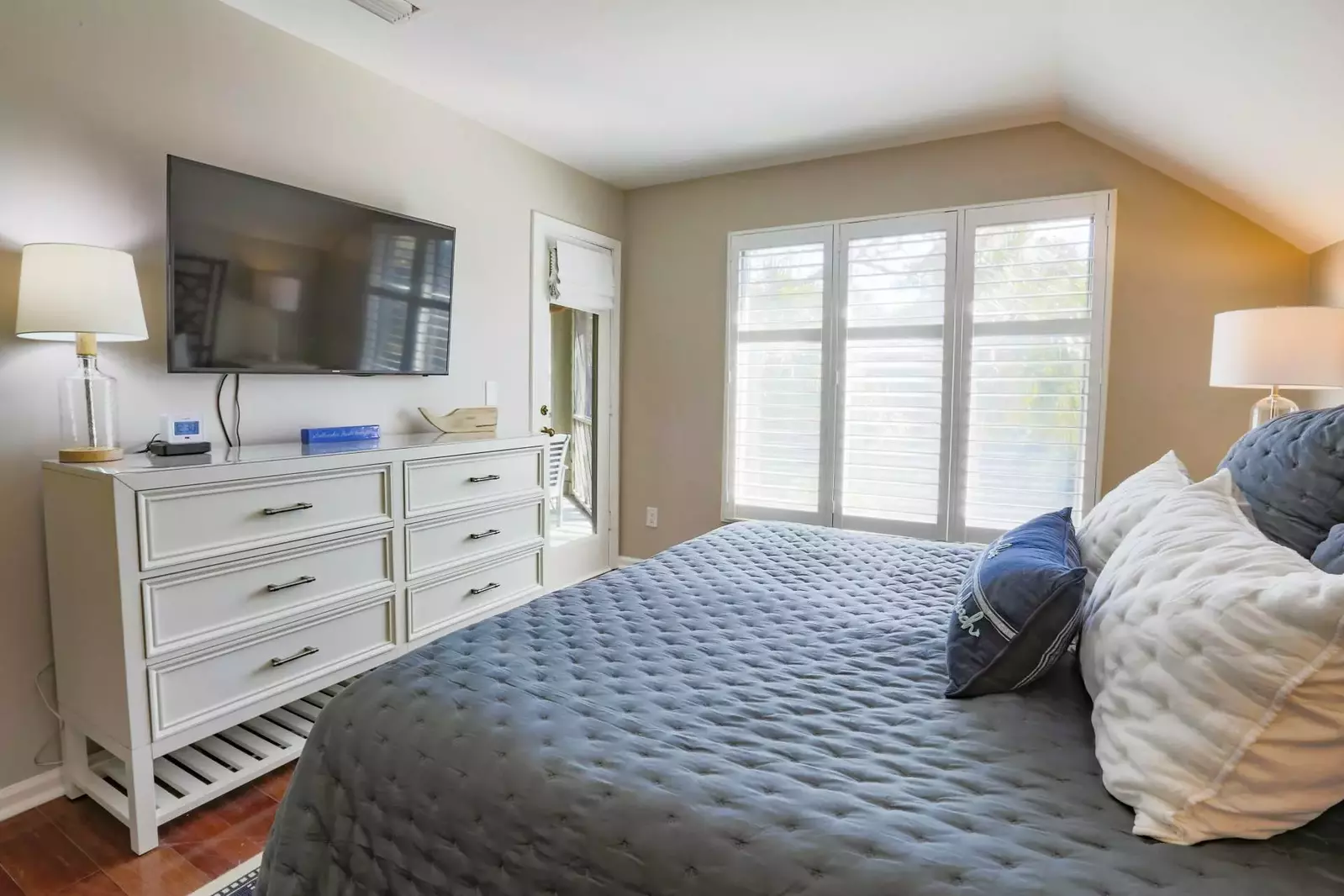 The master suite also has a dresser, mounted TV and access to the screened porch.