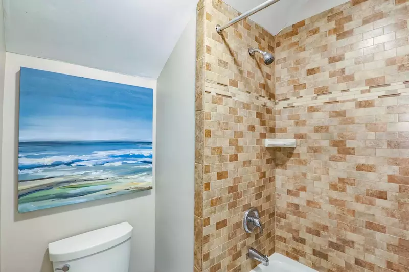 The master bathroom also features this tiled shower/tub combo.