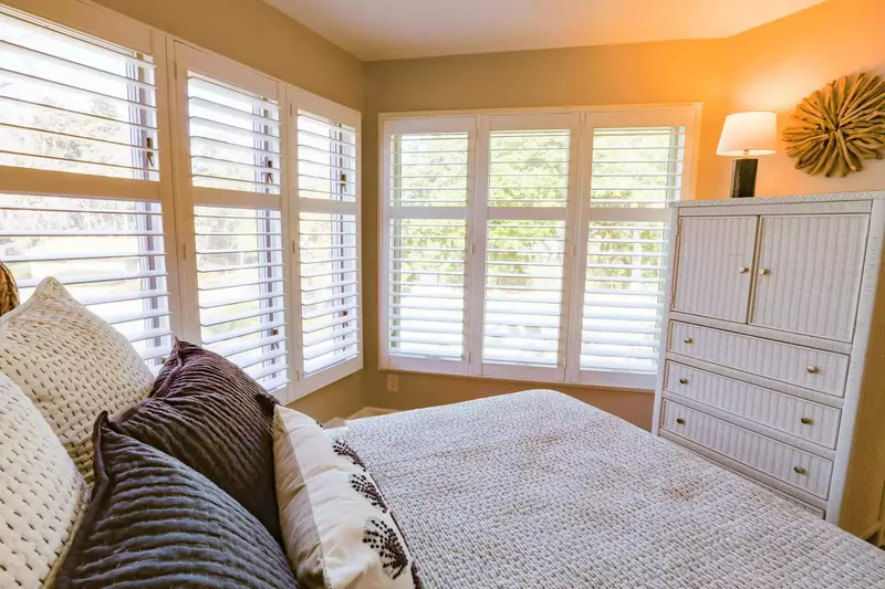 The guest bedroom receives terrific natural light from these large windows that look out the front of the building.