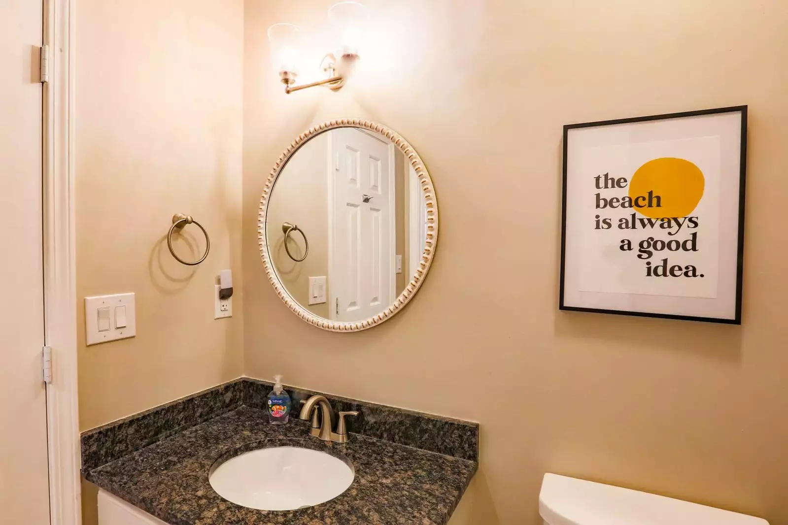 The guest bathroom features a vanity and shower/tub combo.