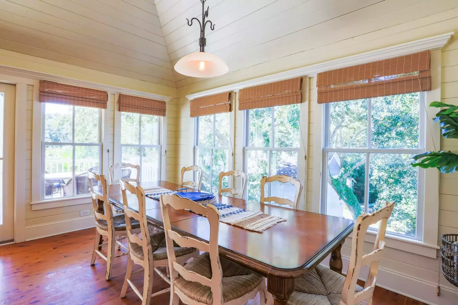 The dining table seats 8 and there are 4 stools at the kitchen island.