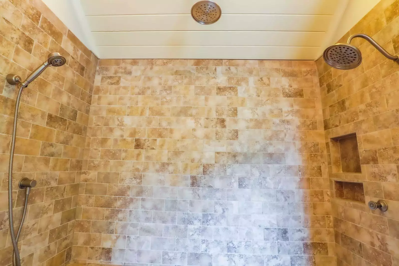 The master bathroom also has this tiled, walk-in shower with multiple shower heads.