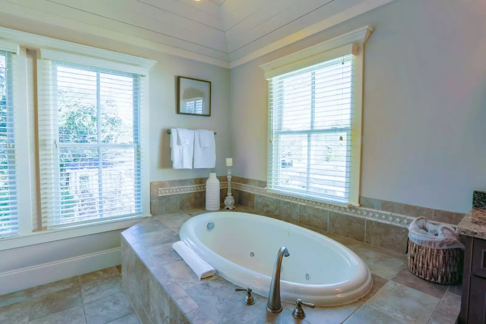 This soaking tub is located in the corner of the spacious master bathroom.